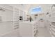Bright walk-in closet with custom built-ins and a center island at 9009 Meadow Pointe Ct, Wake Forest, NC 27587