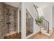 Under-stair wine cellar with glass enclosure and built-in shelving at 9009 Meadow Pointe Ct, Wake Forest, NC 27587