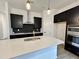 Modern kitchen with dark cabinetry, quartz countertops and a gold faucet at 106 S Harvest Ridge Way # 245, Clayton, NC 27520