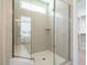 Modern bathroom with a glass-enclosed shower, neutral tile, and a built-in seat at 1721 Grassy Falls Ln, Wendell, NC 27591