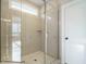 Modern bathroom features a glass enclosed shower, a rain shower head, and marble floors at 1721 Grassy Falls Ln, Wendell, NC 27591