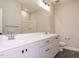 Well-lit bathroom with double sink vanity, white countertops, and modern fixtures at 1721 Grassy Falls Ln, Wendell, NC 27591