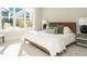 Sunlit bedroom with a large window, a comfortable bed, and stylish decor for a relaxing retreat at 1721 Grassy Falls Ln, Wendell, NC 27591