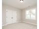 Neutral bedroom with closet, double doors, plush carpet and natural lighting at 1721 Grassy Falls Ln, Wendell, NC 27591
