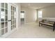 Bright bonus room features plush carpeting, bench seating, and glass panel doors at 1721 Grassy Falls Ln, Wendell, NC 27591