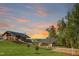 A community building with a covered picnic area set on manicured lawns under a colorful sunset at 1721 Grassy Falls Ln, Wendell, NC 27591