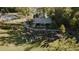 Aerial view of a community event in a park with people sitting on the grass, near a pond and pool at 1721 Grassy Falls Ln, Wendell, NC 27591