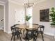 Dining area featuring hardwood floors, a modern light fixture, and a round wooden table with 6 chairs at 1721 Grassy Falls Ln, Wendell, NC 27591
