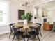 Stylish dining room with modern chandelier, table with 6 black chairs, and hardwood floors at 1721 Grassy Falls Ln, Wendell, NC 27591