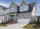 Charming gray two-story home with attached two car garage and well-manicured front lawn at 1721 Grassy Falls Ln, Wendell, NC 27591