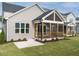 Charming exterior featuring a screened porch, manicured lawn, and inviting curb appeal at 1721 Grassy Falls Ln, Wendell, NC 27591