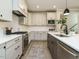 Modern kitchen featuring stainless steel appliances, white cabinets, and a gray island with a white countertop at 1721 Grassy Falls Ln, Wendell, NC 27591