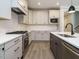 Modern kitchen featuring stainless steel appliances, white cabinets, and a gray island with a white countertop at 1721 Grassy Falls Ln, Wendell, NC 27591