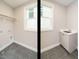 Well lit laundry room featuring a utility sink and space for a washer and dryer at 1721 Grassy Falls Ln, Wendell, NC 27591