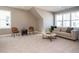 Cozy living room featuring neutral walls, modern furniture, and large windows for abundant natural light at 1721 Grassy Falls Ln, Wendell, NC 27591