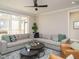 Cozy living room features a large sectional, modern decor, and sliding doors leading to a screened deck at 1721 Grassy Falls Ln, Wendell, NC 27591