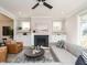 Stylish living room with a fireplace, comfortable seating, and built-in shelving and cabinets at 1721 Grassy Falls Ln, Wendell, NC 27591