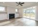 Bright living room with a fireplace, built-in cabinets, and sliding doors to the deck, with natural light at 1721 Grassy Falls Ln, Wendell, NC 27591