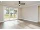 Bright and open living room with sliding glass doors leading to a wooden deck; perfect for indoor-outdoor living at 1721 Grassy Falls Ln, Wendell, NC 27591