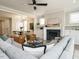 Comfortable living room with a black fireplace, a ceiling fan and a large sectional couch at 1721 Grassy Falls Ln, Wendell, NC 27591