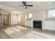 Well-lit living room with sleek hardwood floors, a fireplace and an open concept layout to the kitchen at 1721 Grassy Falls Ln, Wendell, NC 27591