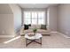Living room with bright window, plush carpet and comfy couch at 1721 Grassy Falls Ln, Wendell, NC 27591