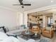 Spacious living room showcasing hardwood floors, a ceiling fan, and an open floor plan to the kitchen at 1721 Grassy Falls Ln, Wendell, NC 27591