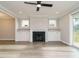 Inviting living room features a cozy fireplace, built-in shelving, and access to the outdoor deck at 1721 Grassy Falls Ln, Wendell, NC 27591