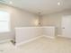 Neutral loft space with carpet, half wall, pendant light and access door at 1721 Grassy Falls Ln, Wendell, NC 27591