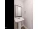 Clean powder room featuring a pedestal sink, a mirror and neutral walls at 1721 Grassy Falls Ln, Wendell, NC 27591