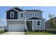 Two-story house with gray siding, white trim, and a two-car garage at 805 Emmer St, Rolesville, NC 27571