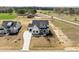 Aerial view of a stately two-story home showcasing landscaping, driveway, and surrounding neighborhood at 110 Summerlin Dr, Clayton, NC 27527