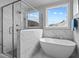 Bathroom features soaking tub, glass shower and large window for natural light at 110 Summerlin Dr, Clayton, NC 27527