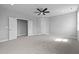 Bright bedroom with plush carpeting, a ceiling fan, and ample closet space, illuminated by natural light at 110 Summerlin Dr, Clayton, NC 27527