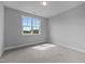 Bright bedroom with soft carpeting and a large window providing natural light and showcasing scenic outdoor views at 110 Summerlin Dr, Clayton, NC 27527