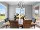 Bright dining area with a wooden table, wicker chairs, and a picturesque view at 110 Summerlin Dr, Clayton, NC 27527