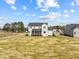 Wide shot of the home exterior showcasing a screened porch and large yard surrounded by other houses at 110 Summerlin Dr, Clayton, NC 27527