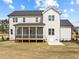 Back exterior view of a two-story home with a screened-in porch and well-maintained lawn at 110 Summerlin Dr, Clayton, NC 27527