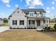 Charming two-story home featuring stone accents, a covered porch, and manicured landscaping at 110 Summerlin Dr, Clayton, NC 27527