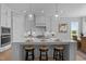 Spacious kitchen featuring a large island with seating, modern appliances, and pendant lighting at 110 Summerlin Dr, Clayton, NC 27527