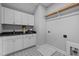 Functional laundry room featuring ample cabinet space, modern appliances hook-ups, and a patterned floor at 110 Summerlin Dr, Clayton, NC 27527