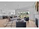 Open concept living room, dining, and kitchen with hardwood floors and sliding glass door to outside deck at 110 Summerlin Dr, Clayton, NC 27527