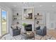 Living room with fireplace and built-in shelves with contemporary artwork above mantel at 110 Summerlin Dr, Clayton, NC 27527