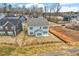 Aerial view of a light blue two-story home featuring a well-maintained backyard in a residential neighborhood at 219 Berry Mill Ln # 179, Raleigh, NC 27603