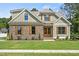 Attractive home featuring stone accents, vertical siding and a beautiful lawn at 112 Lambert Ln, Fuquay Varina, NC 27526