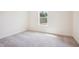 Empty bedroom featuring new carpeting and a large window with natural light at 73 Artic Cir, Garner, NC 27529