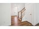 Spacious foyer featuring hardwood floors, a staircase, and a view of the front door at 73 Artic Cir, Garner, NC 27529