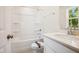 Bathroom with shower-tub combination, white vanity with chrome fixtures and natural light from a window at 73 Artic Cir, Garner, NC 27529