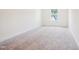 Neutral bedroom featuring a window to let in natural light and neutral carpet at 73 Artic Cir, Garner, NC 27529