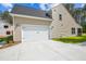 Attached two-car garage featuring a paved driveway and well-maintained exterior at 73 Artic Cir, Garner, NC 27529